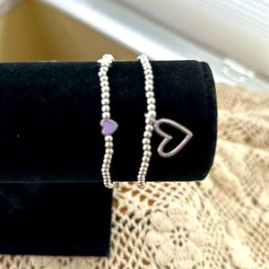 Set of two UK brand Katie Loxton stretch heart bracelets, silver toned.
